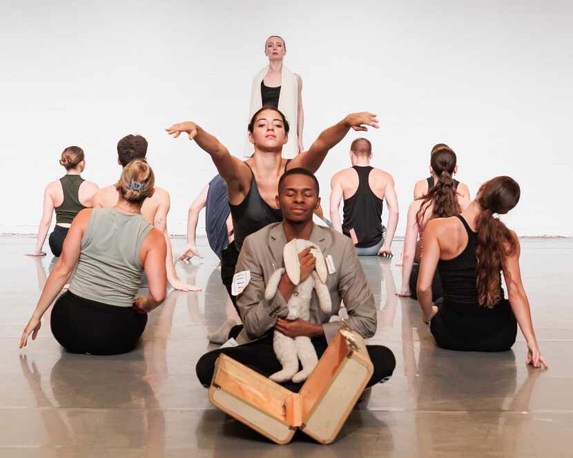 Bruce Wood Dance company member Kevyn Butler, front, portrays an immigrant who misses home...