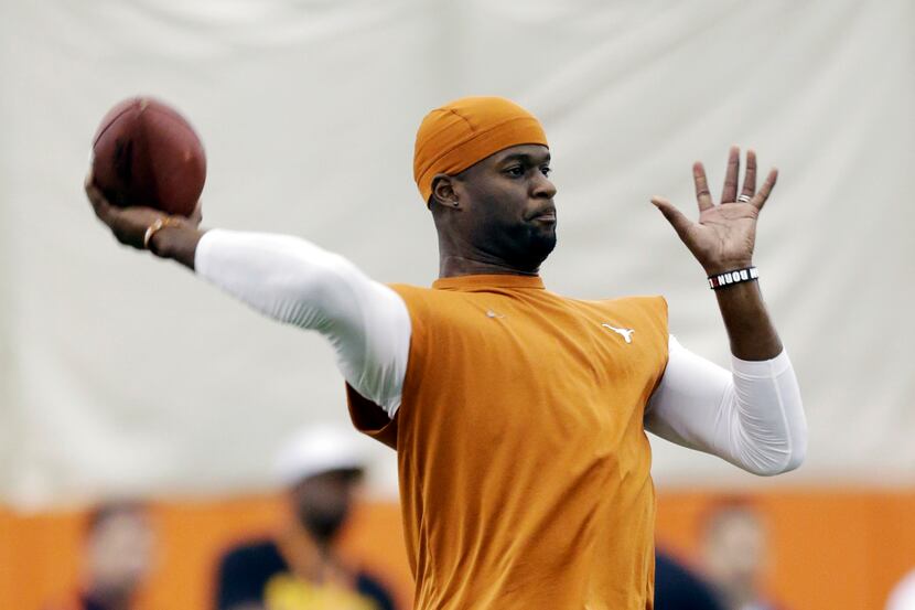 Texas alum and former NFL quarterback Vince Young throws for scouts at Texas' NFL football...