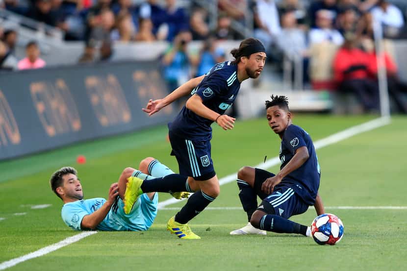 LOS ANGELES, CALIFORNIA - APRIL 21:  Lee Nguyen #24 and Latif Blessing #7 of Los Angeles FC...