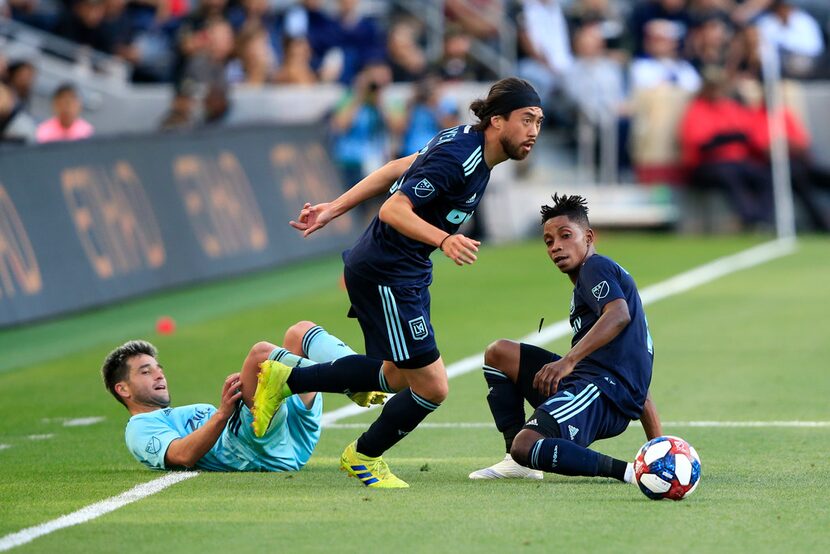 LOS ANGELES, CALIFORNIA - APRIL 21:  Lee Nguyen #24 and Latif Blessing #7 of Los Angeles FC...