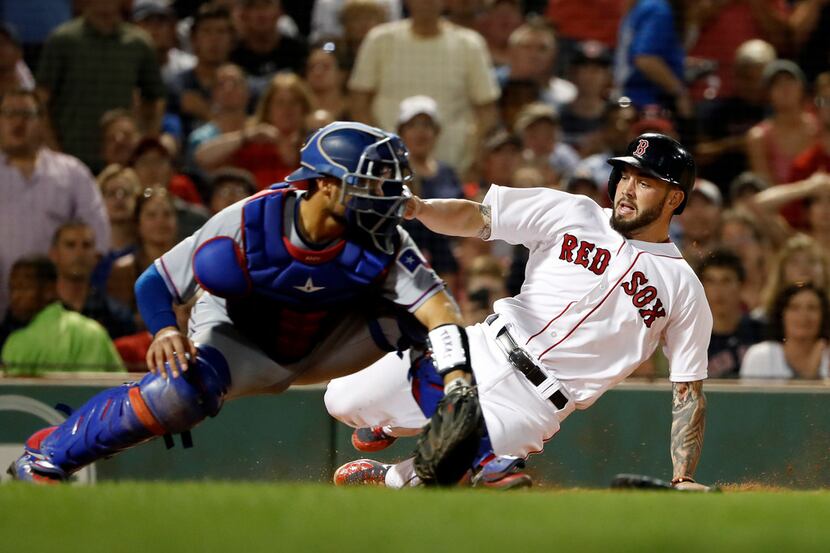 Boston Red Sox's Blake Swihart slides home safely as Texas Rangers shortstop Isiah...