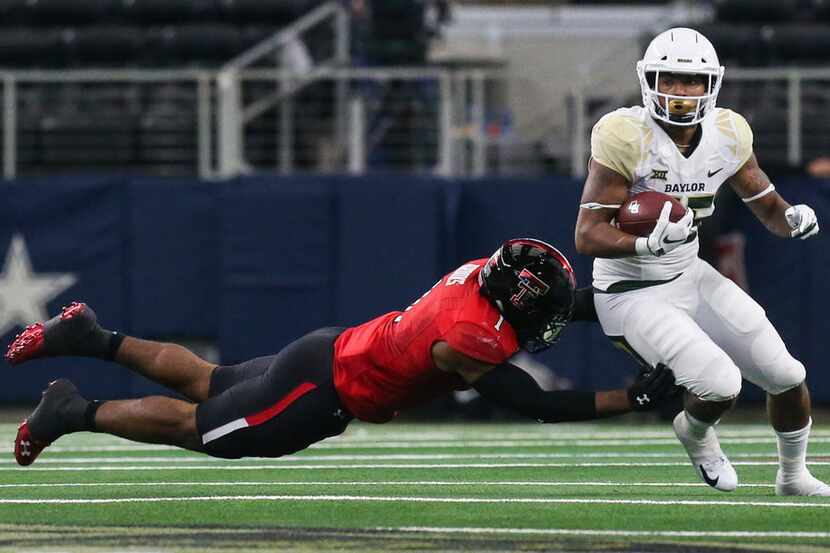 FILE - Texas Tech Red Raiders linebacker Jordyn Brooks (1) attempts to bring down Baylor...