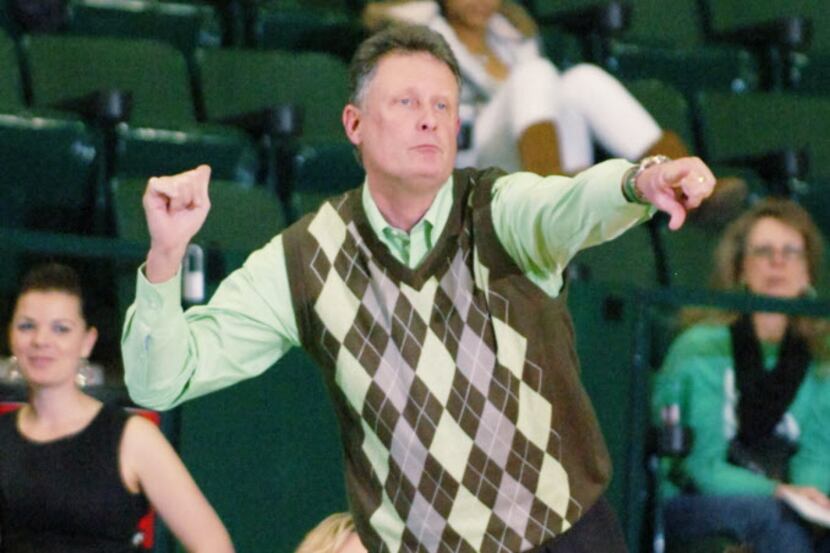 University of North Texas women's basketball head coach Mike Peterson directs a play from...