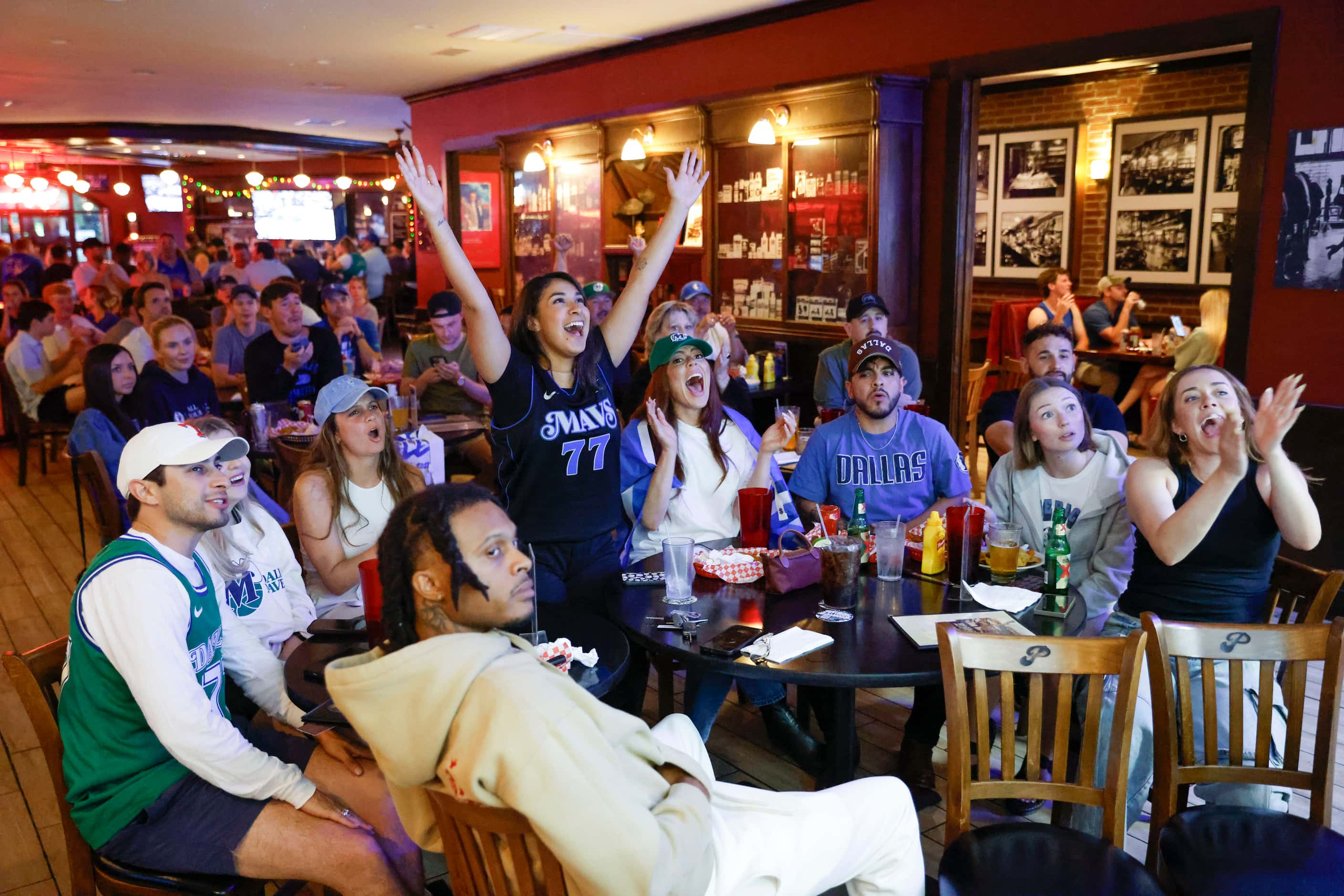 Jackie Fuentes (center), of Dallas, cheers alongside others while watching game 5 of NBA...