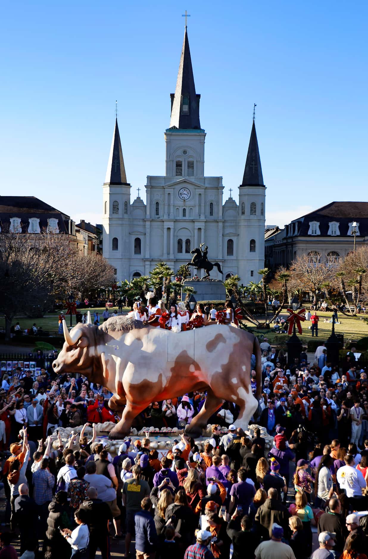 Texas Longhorns cheerleaders ride atop a large longhorn float during the Mardi Gras-style...