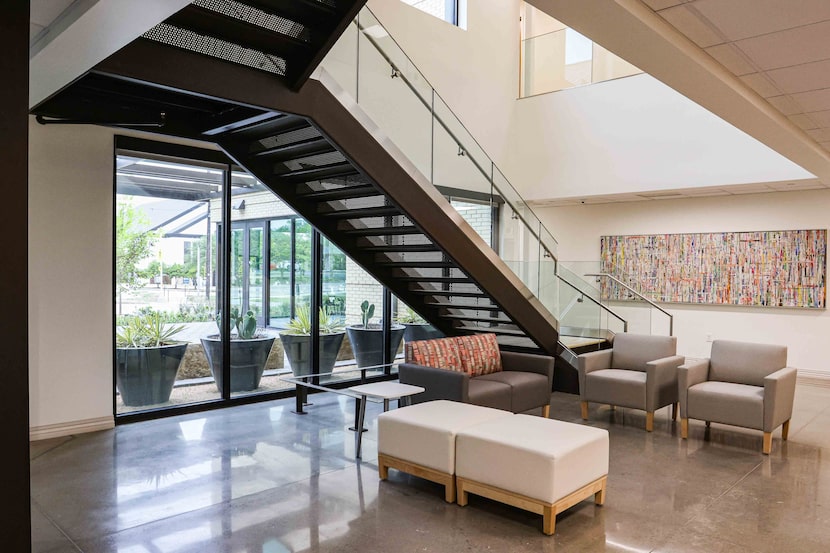 A double-height lobby area with open staircase at the Family Health Center on Virginia in...