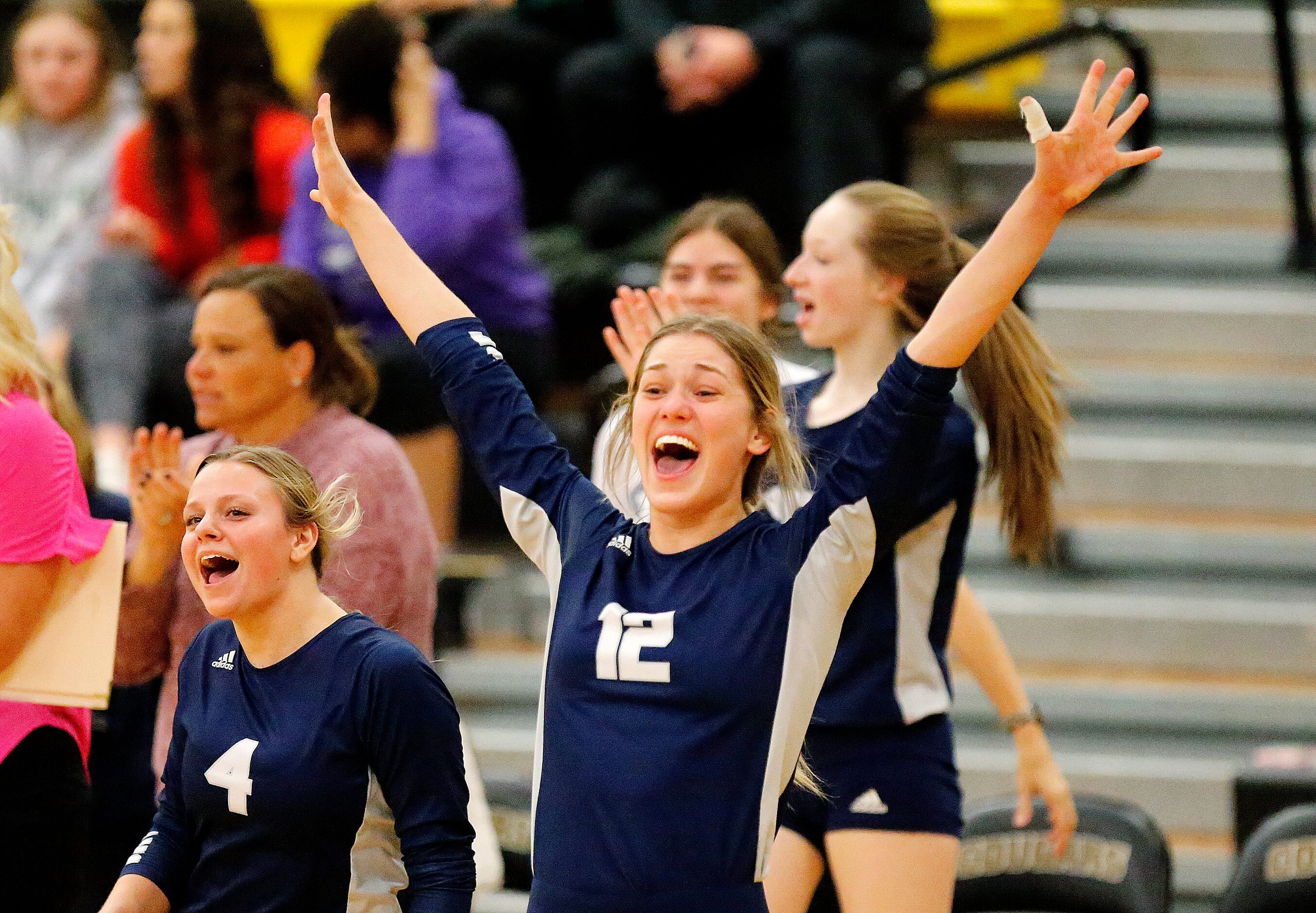 Flower Mound High School middle blocker Emma Radon (12) celebrates a point during game one...