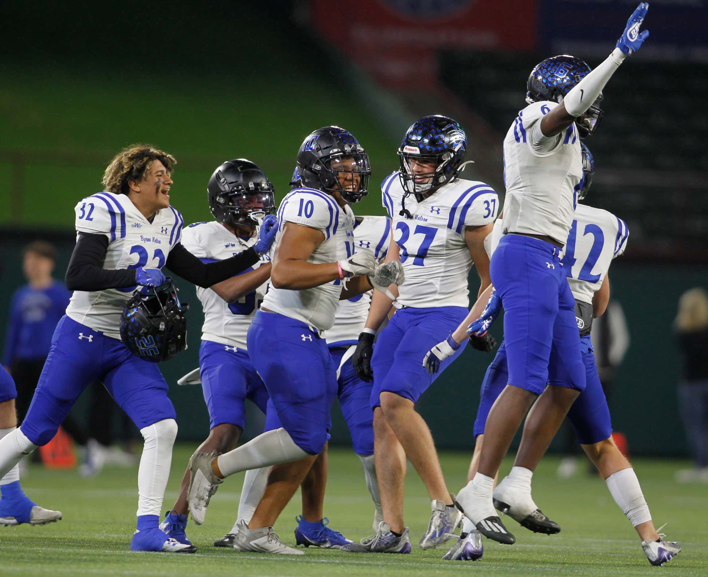 Byron Nelson players celebrate after the final play of their 52-45 victory over Coppell to...