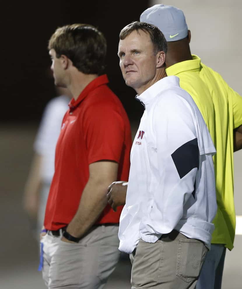SMU's head football coach Chad Morris watches the game from the end zone between Allen High...