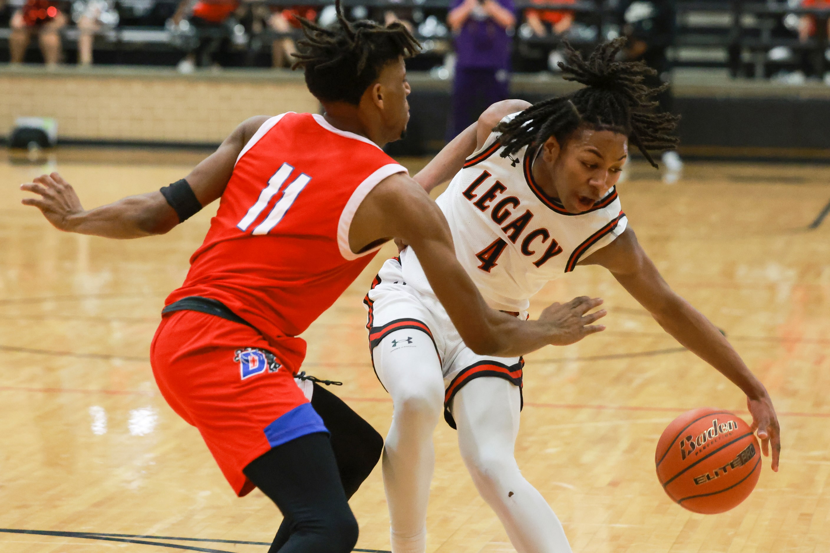 Mansfield Legacy High School’s Amir McMillian (4) dribbles around Duncanville High School’s...