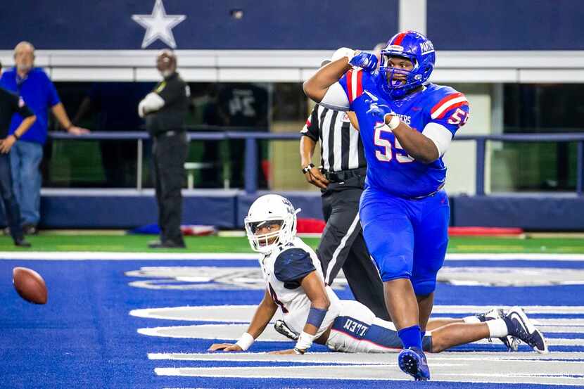 Duncanville defensive lineman De'Braylon Carroll (55) flexes in celebration after sacking...