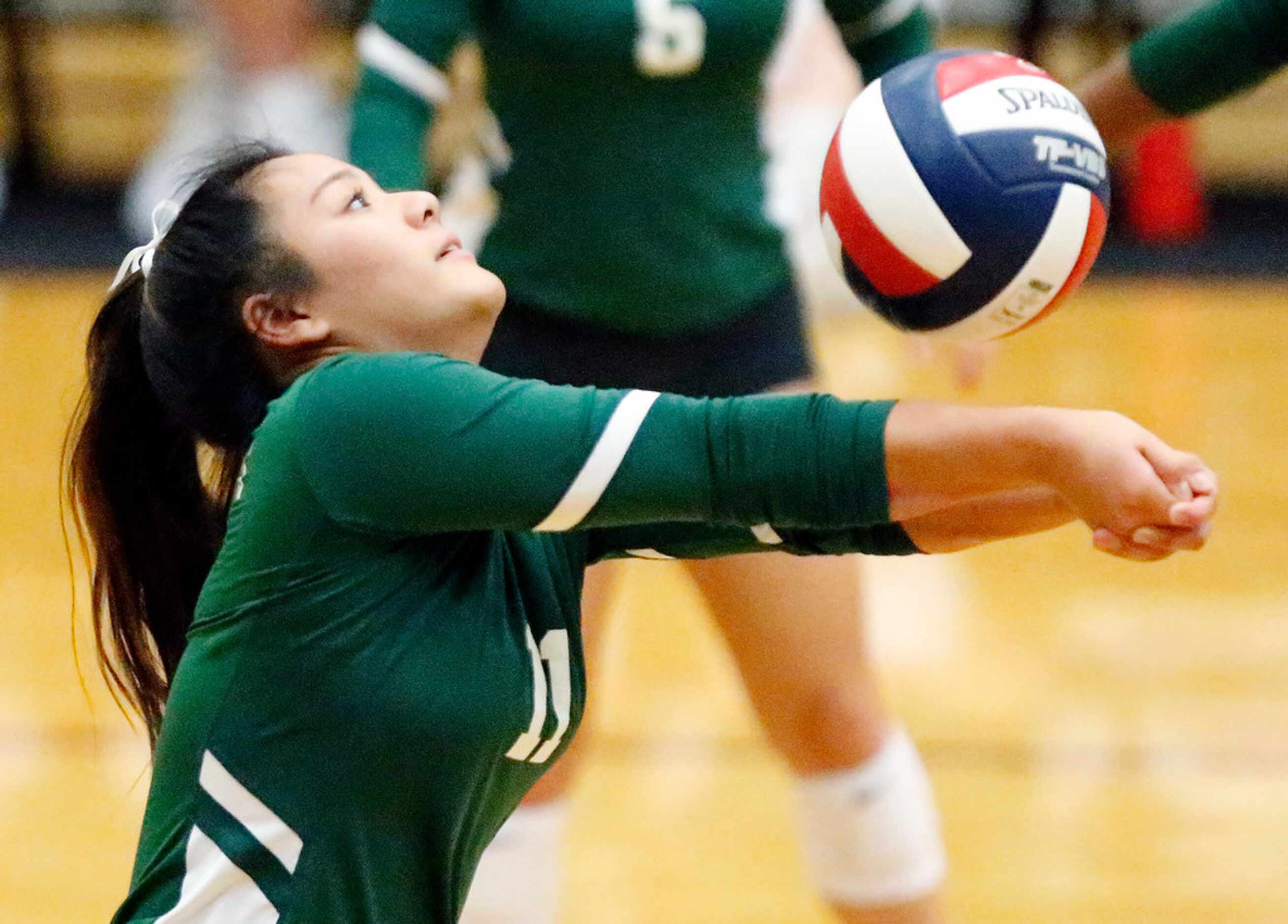 Lebanon Trail High School setter Xuan Nguyen (11) bump sets the volleyball during game one...