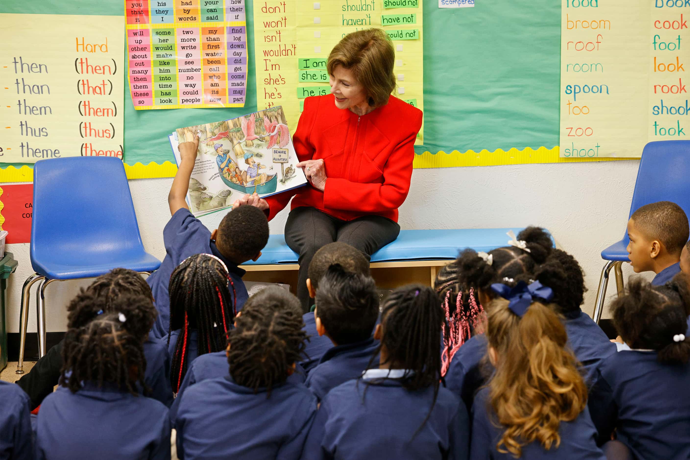 First grader Tavion Jiles, left, talks to former first lady Laura Bush, as she reads "Our...