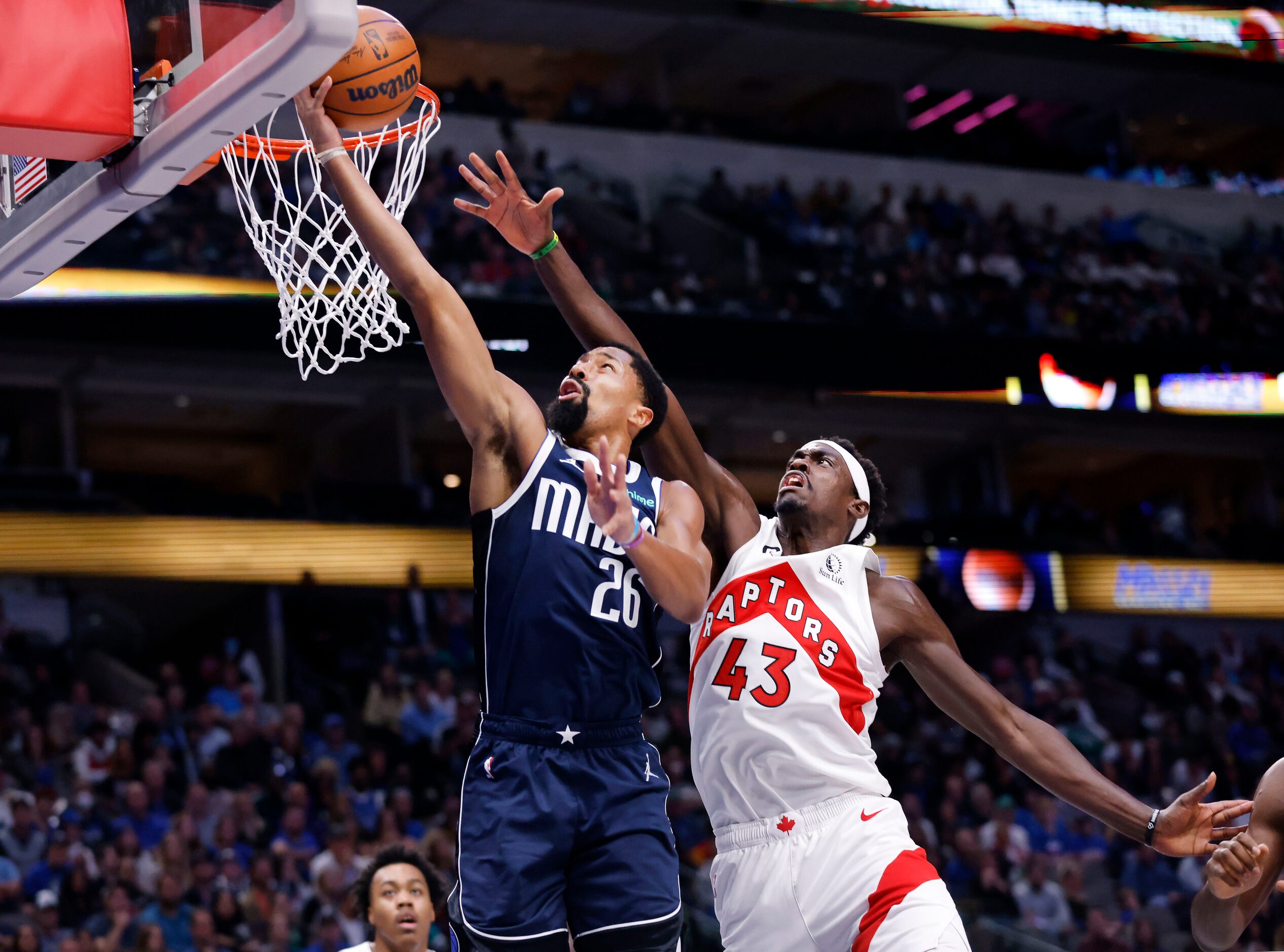 Dallas Mavericks guard Spencer Dinwiddie (26) lays up a shot ahead of Toronto Raptors...