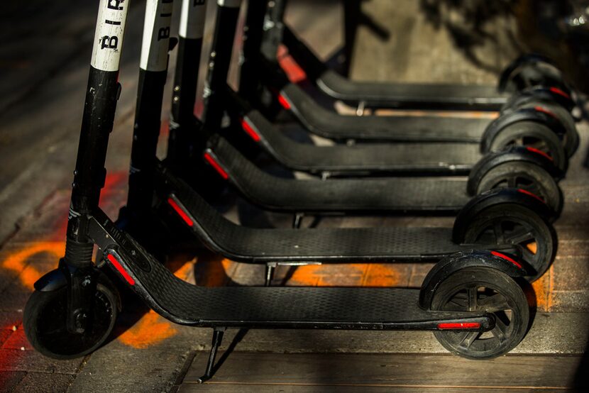 Bird scooters parked near the curb at the 1400 block of Main Street in Downtown Dallas on...