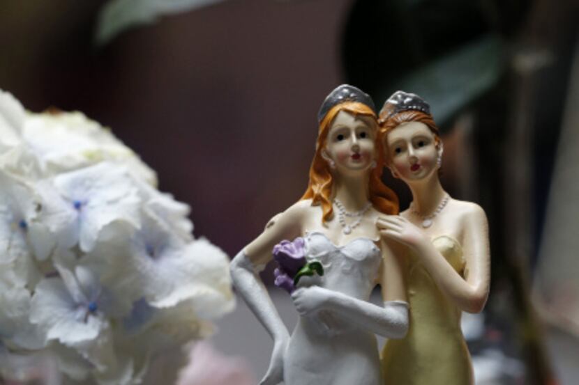 Picture taken on April 27, 2013 in Paris shows plastic figurines of same-sex couples...