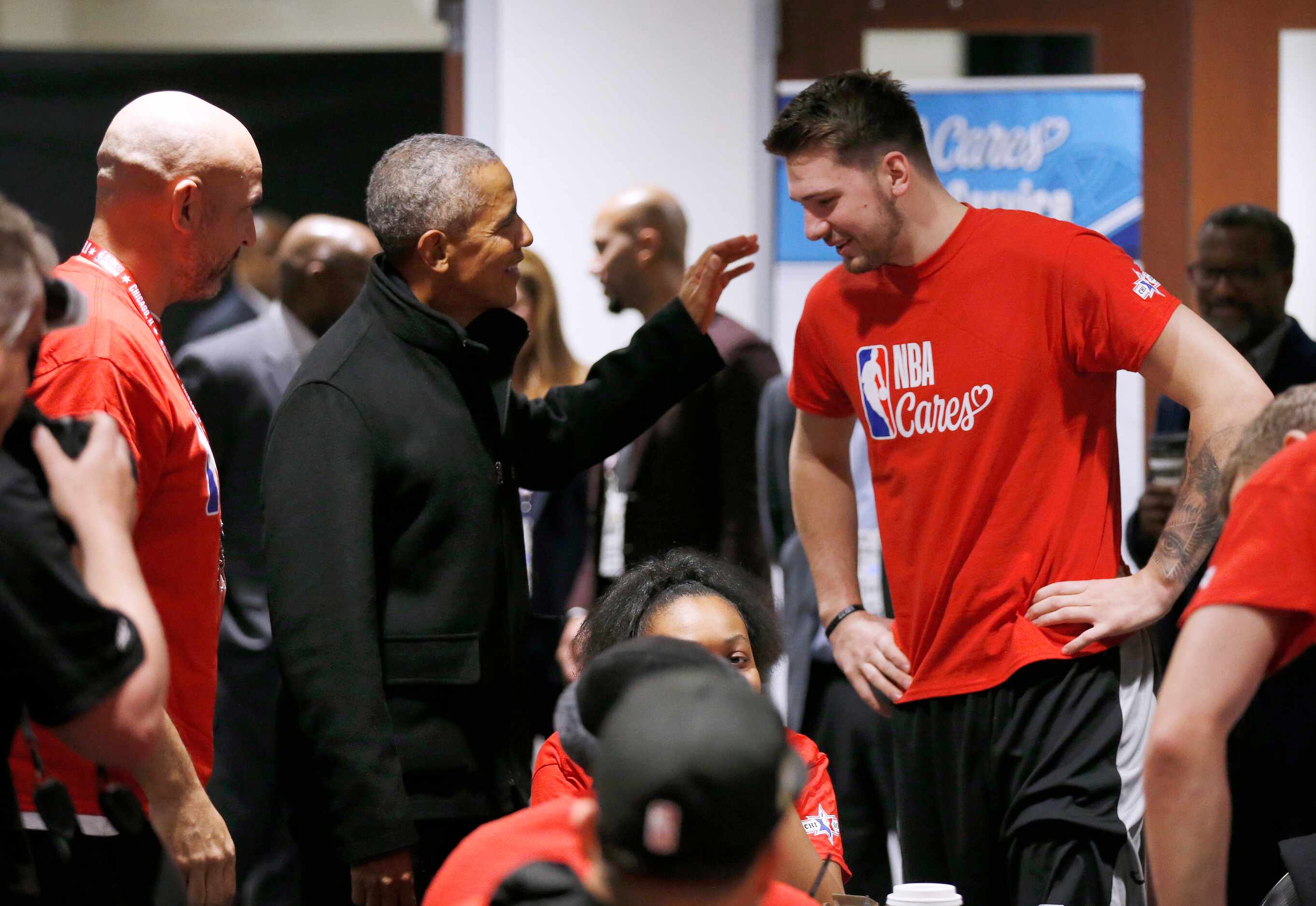 Former President Barack Obama jokes with Los Angeles Lakers assistant coach Jason Kidd as he...
