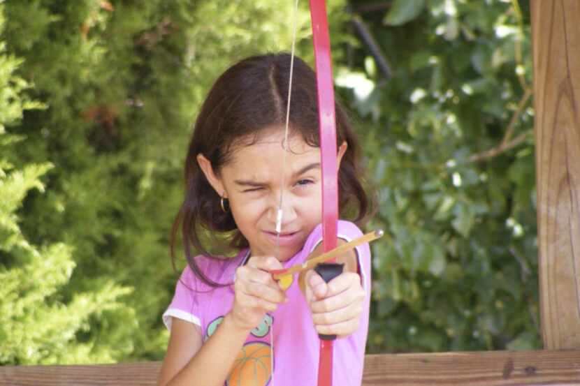 Maranty Campuzano tries her hand at archery during a summer session at Camp Rorie-Galloway...