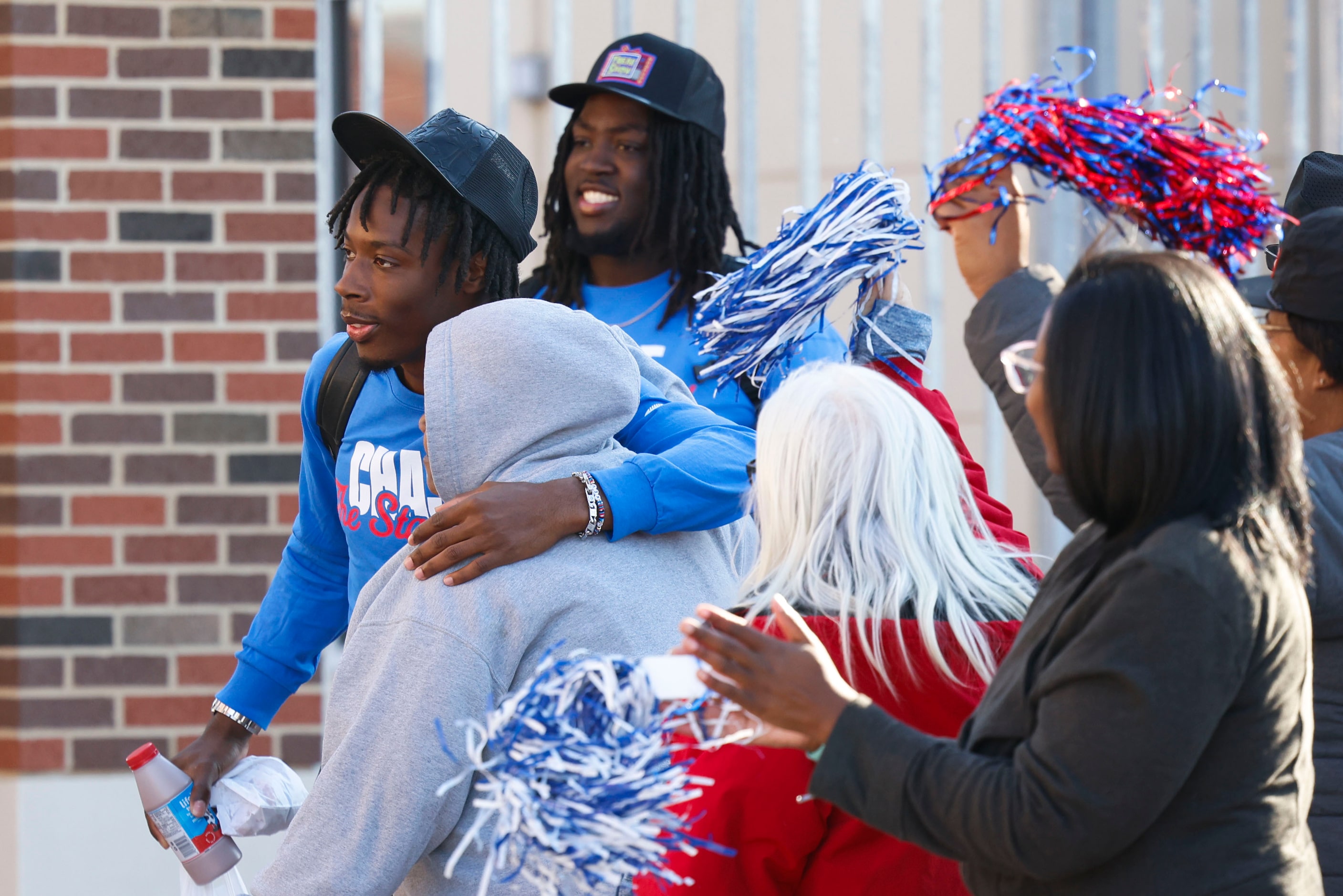 SMU QB Kevin Jennings greets the fans as he make his way out alongside his teammates during...