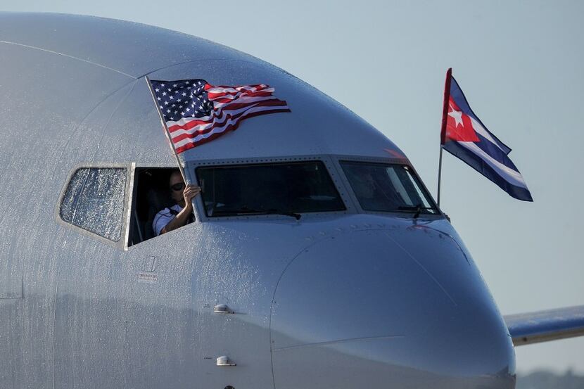 An American Airlines plane fluttering US and Cuba national flags is seen upon arrival at...