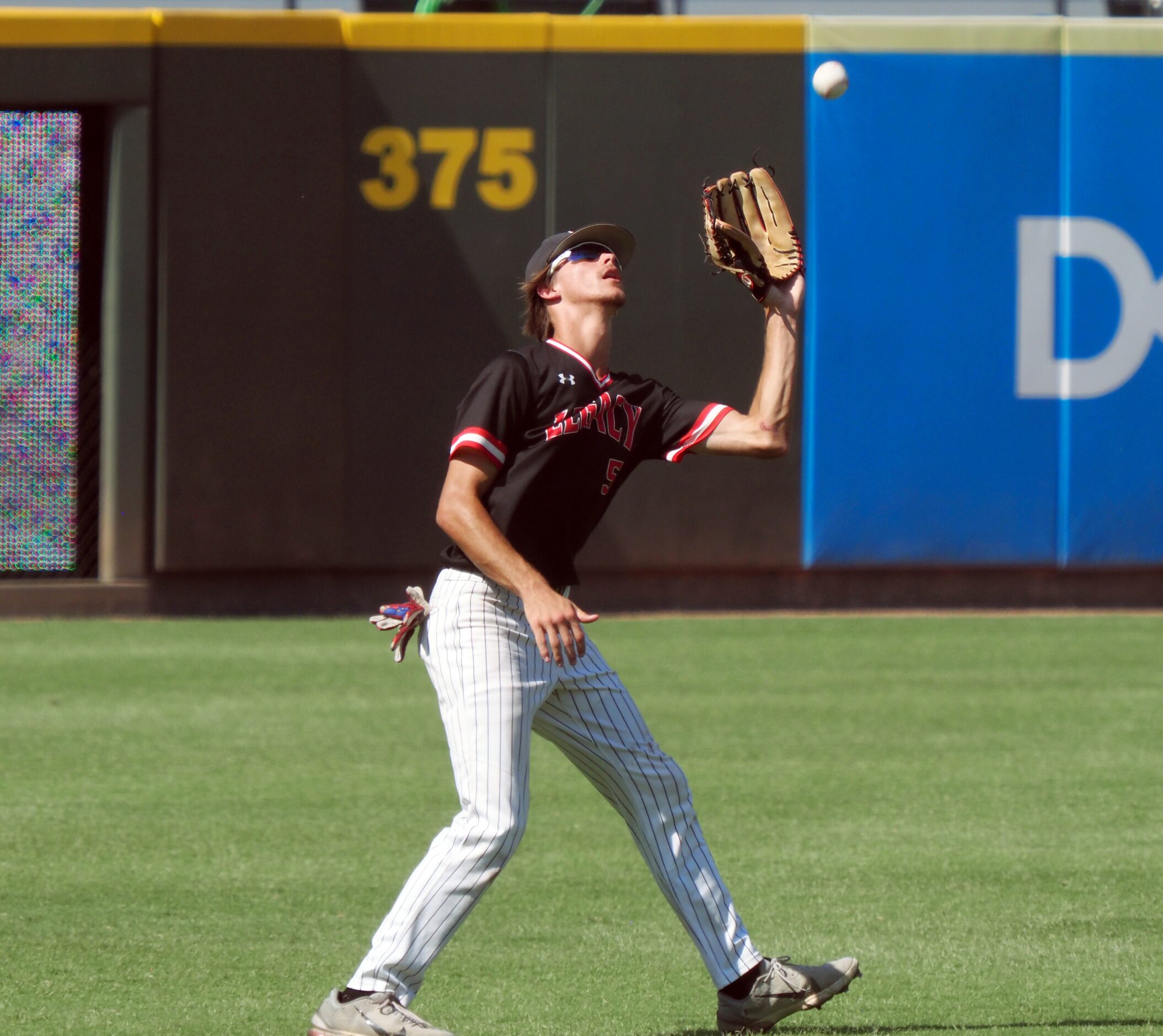 Mansfield Legacy left fielder JT Longino (5) makes a catch for an out against Friendswood in...