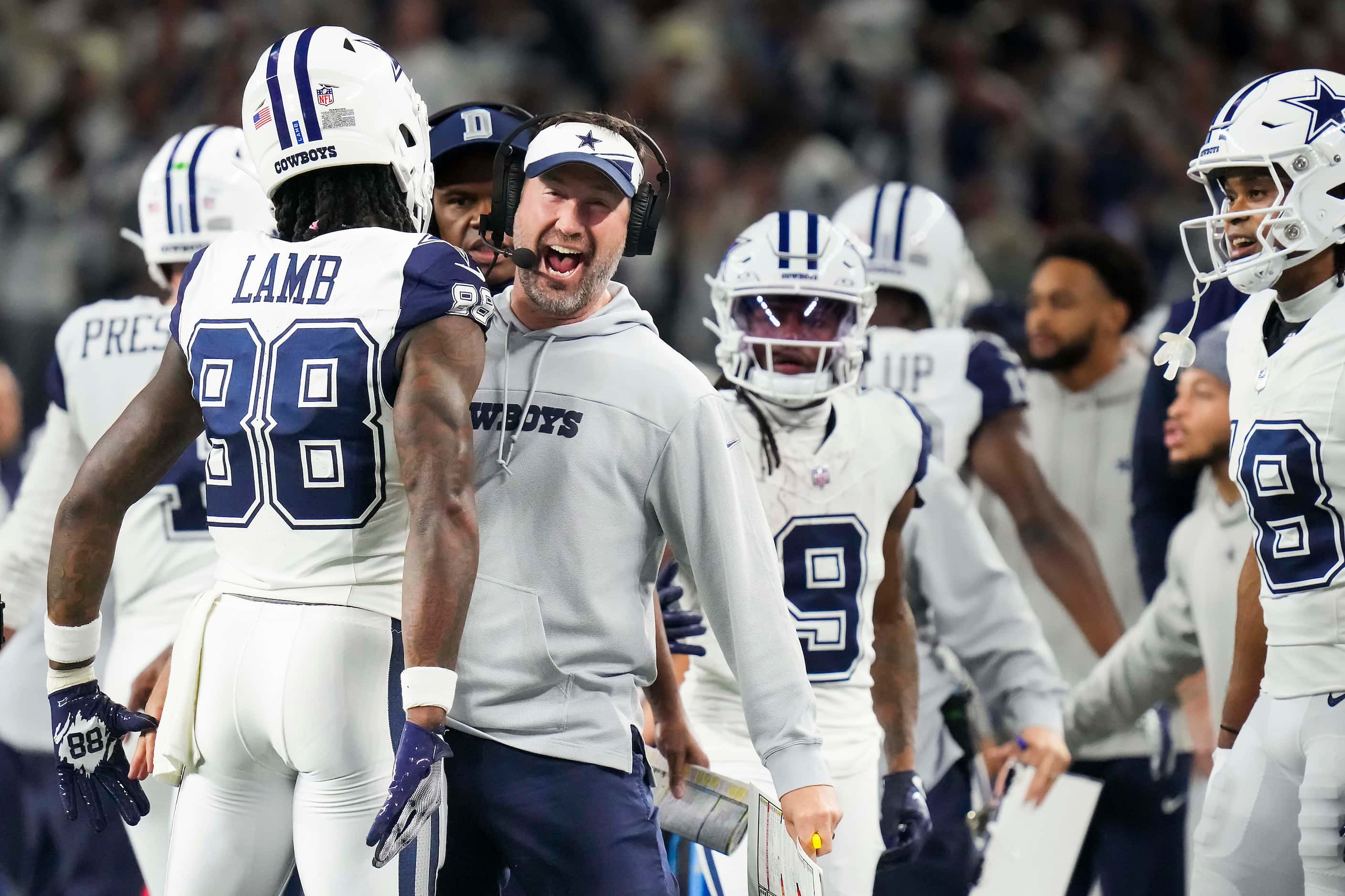 Dallas Cowboys wide receiver CeeDee Lamb (88) celebrates with offensive coordinator Brian...