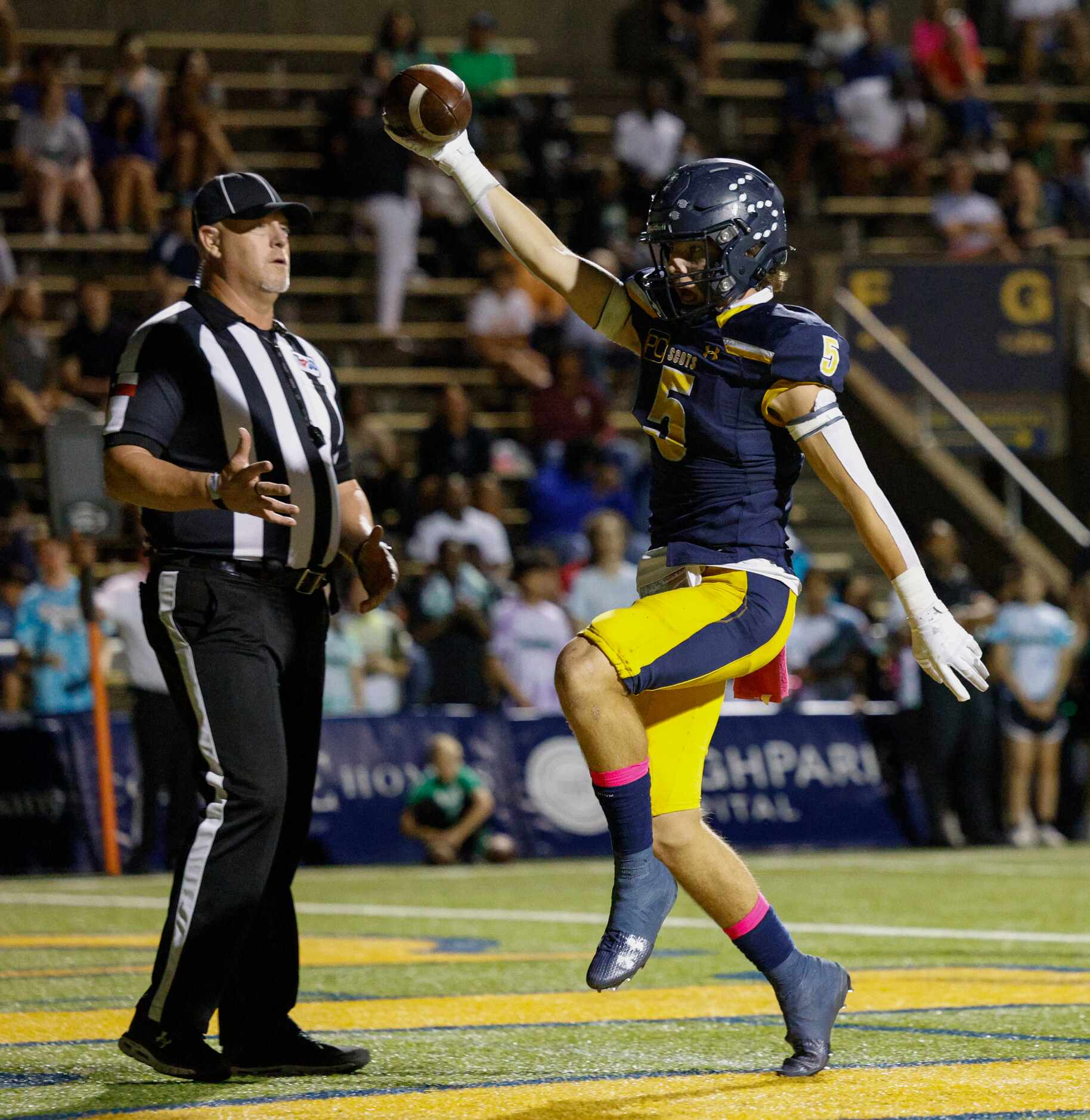 Highland Park running back Keller Holmes (5) celebrates a rushing touchdown during the first...