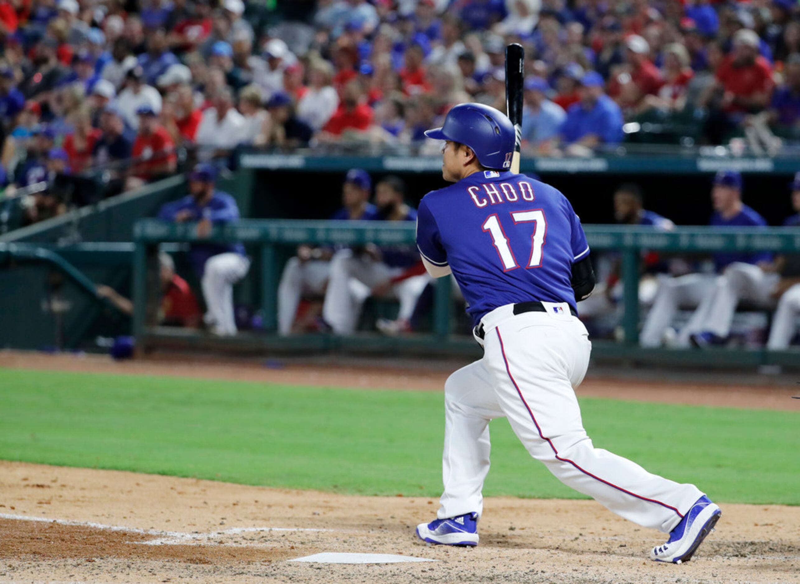 Texas Rangers' Shin-Soo Choo follows through on a run-scoring single in the fourth inning of...
