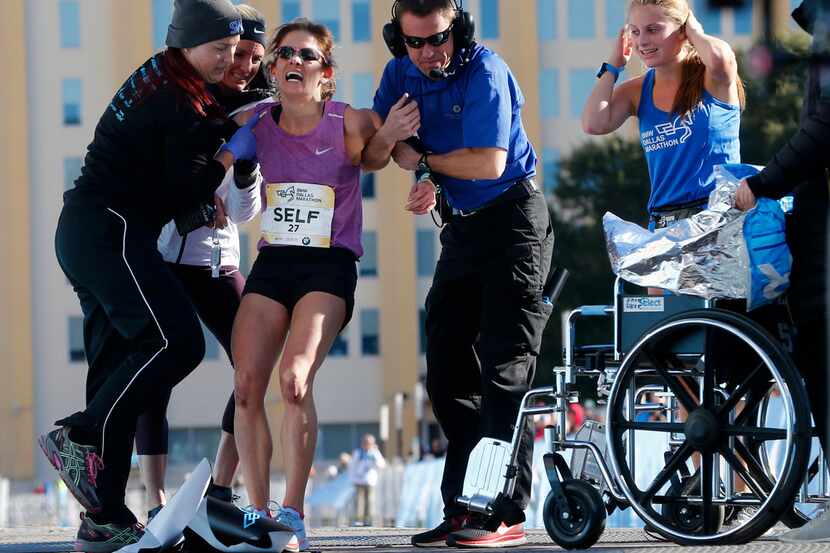 Chandler Self is put in a wheelchair after falling down at the finish line after winning the...