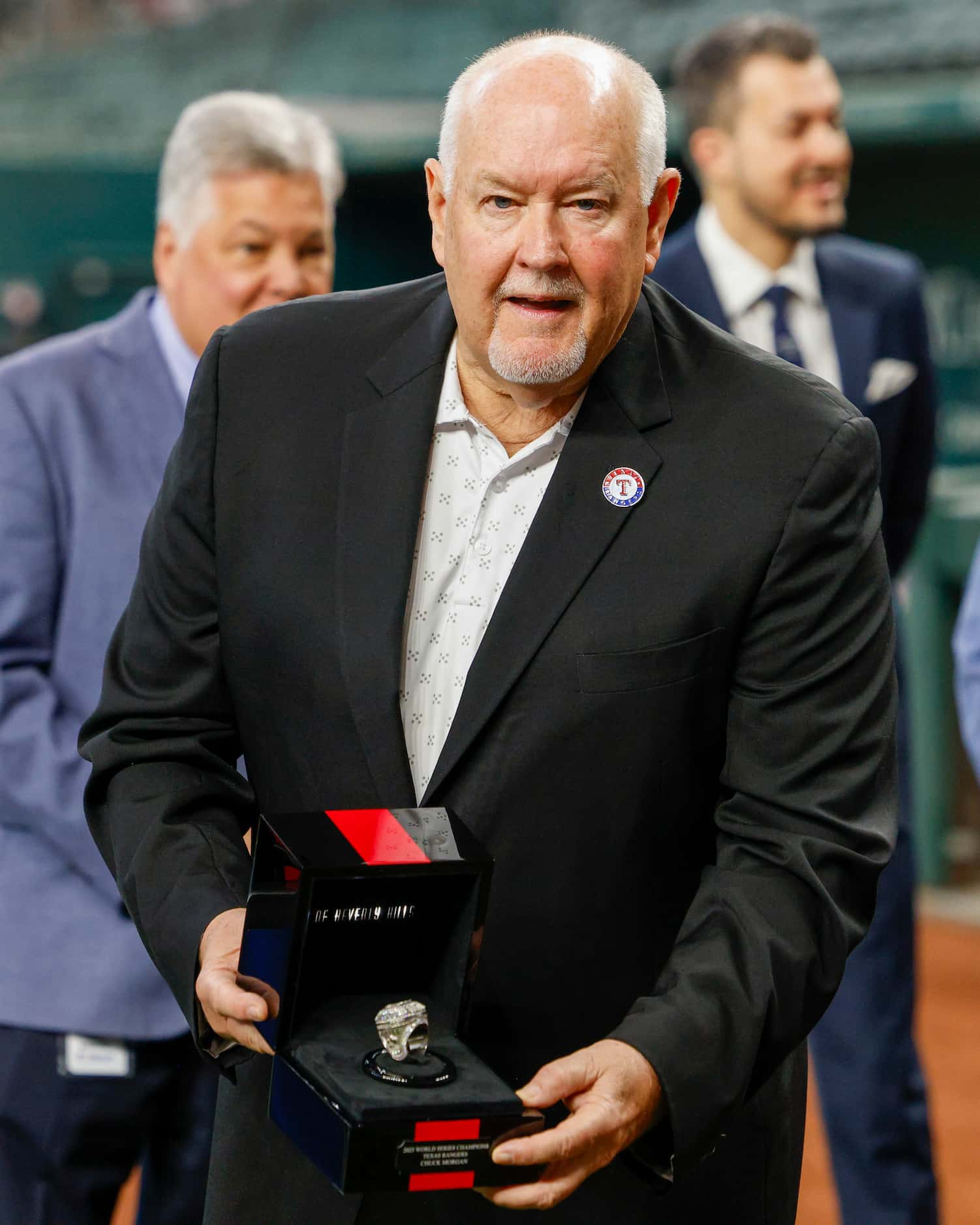 Chuck Morgan, Texas Rangers public address announcer, shows of his World Series championship...