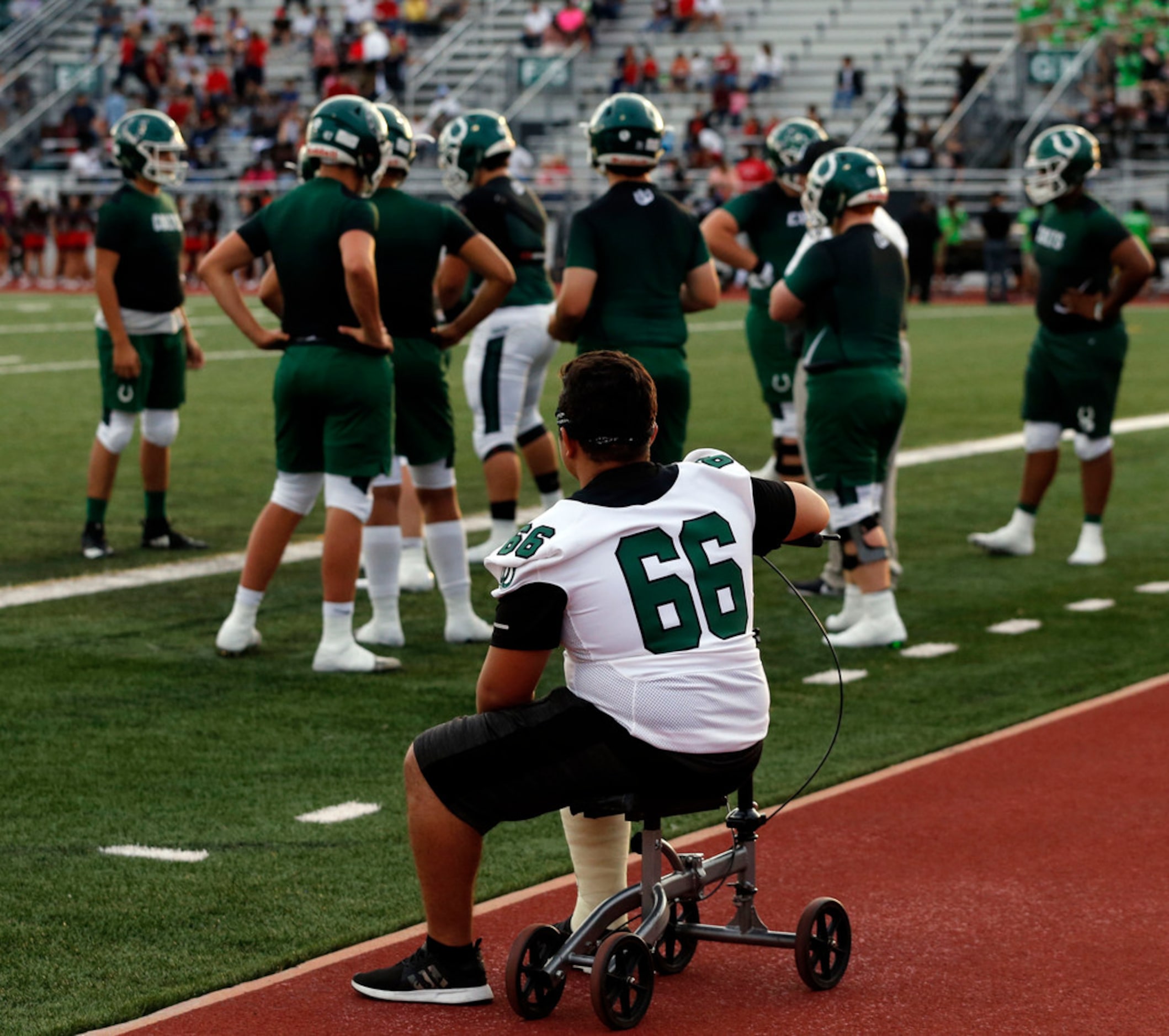 Arlington High injured lineman Jerson Alas (66) watches the line drill before the start of...