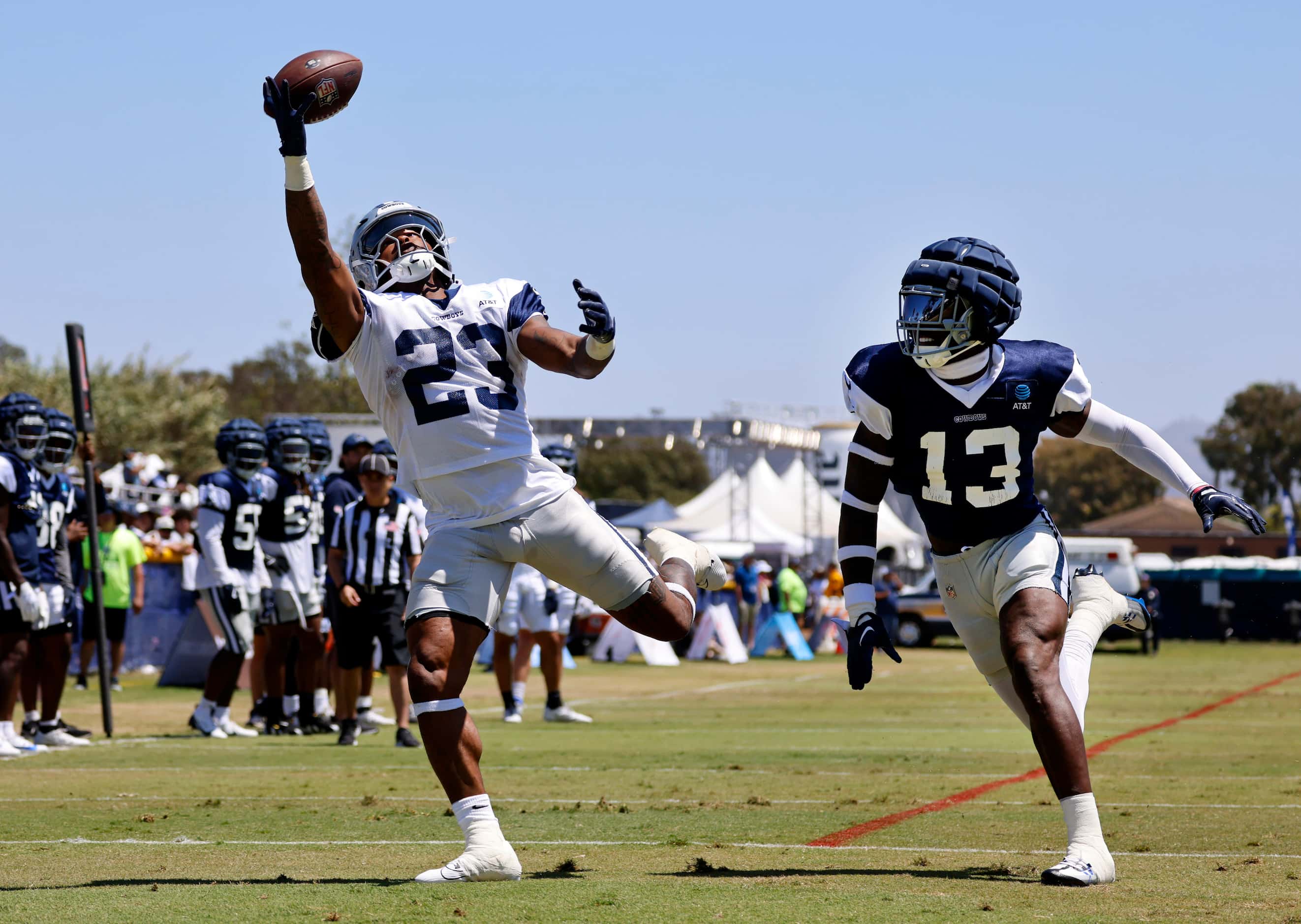 Dallas Cowboys running back Rico Dowdle (23) makes a one-handed touchdown pass against...