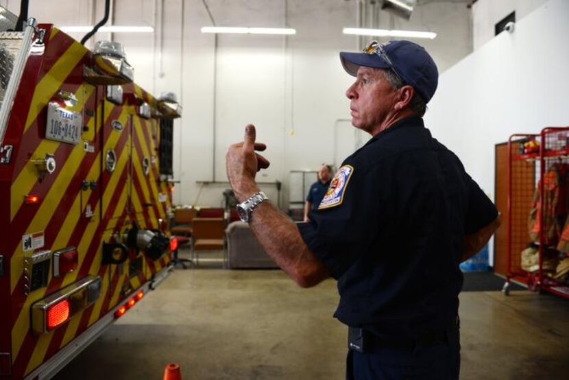 
Craig Merritt directs a driver as he backs a fire engine into the station. The Rockwall...