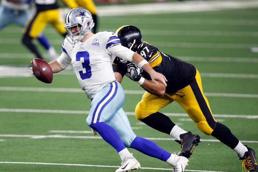 Dallas Cowboys quarterback Garrett Gilbert (3) tries to elude a sack attempt by Pittsburgh...
