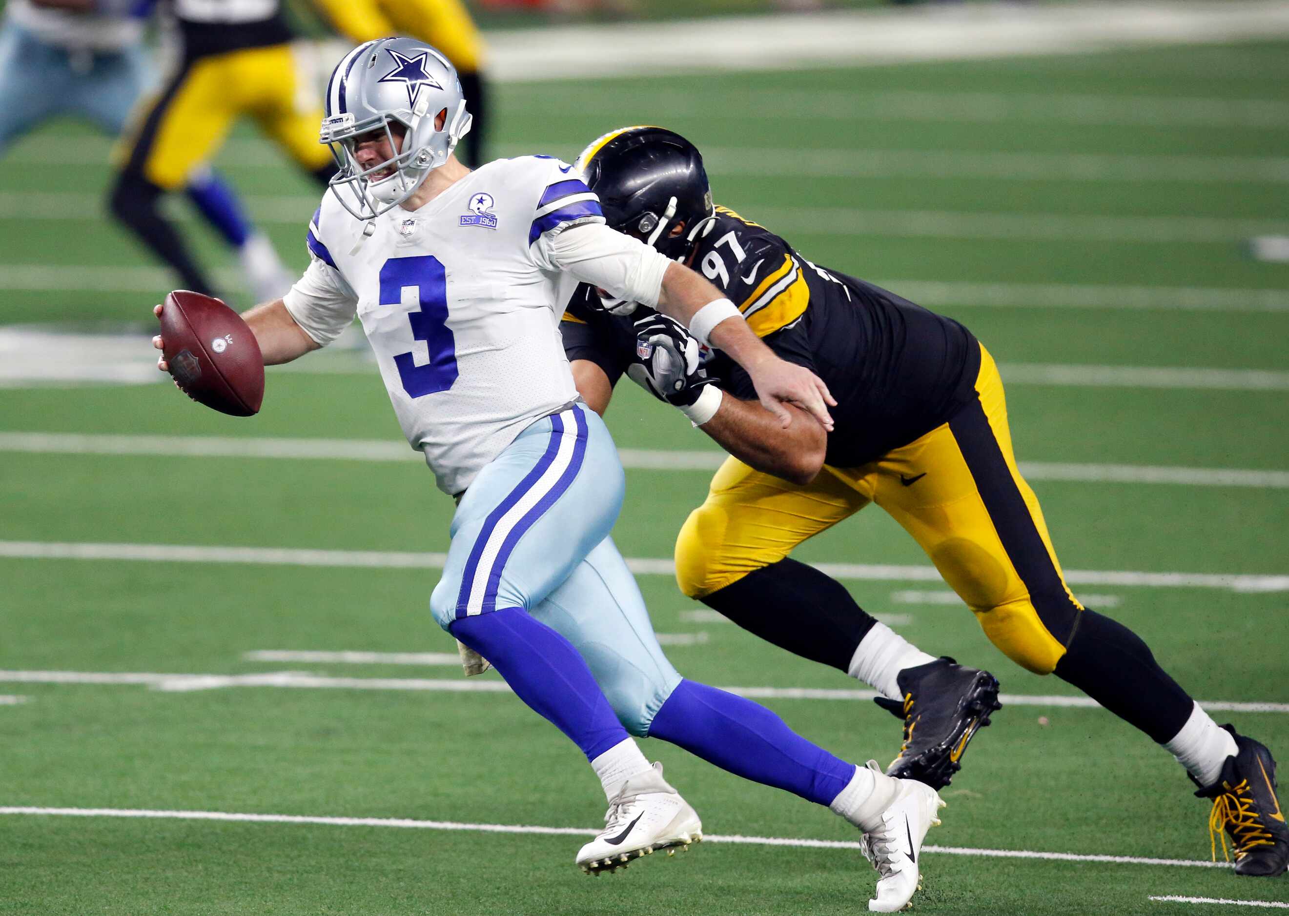 Dallas Cowboys quarterback Garrett Gilbert (3) tries to elude a sack attempt by Pittsburgh...