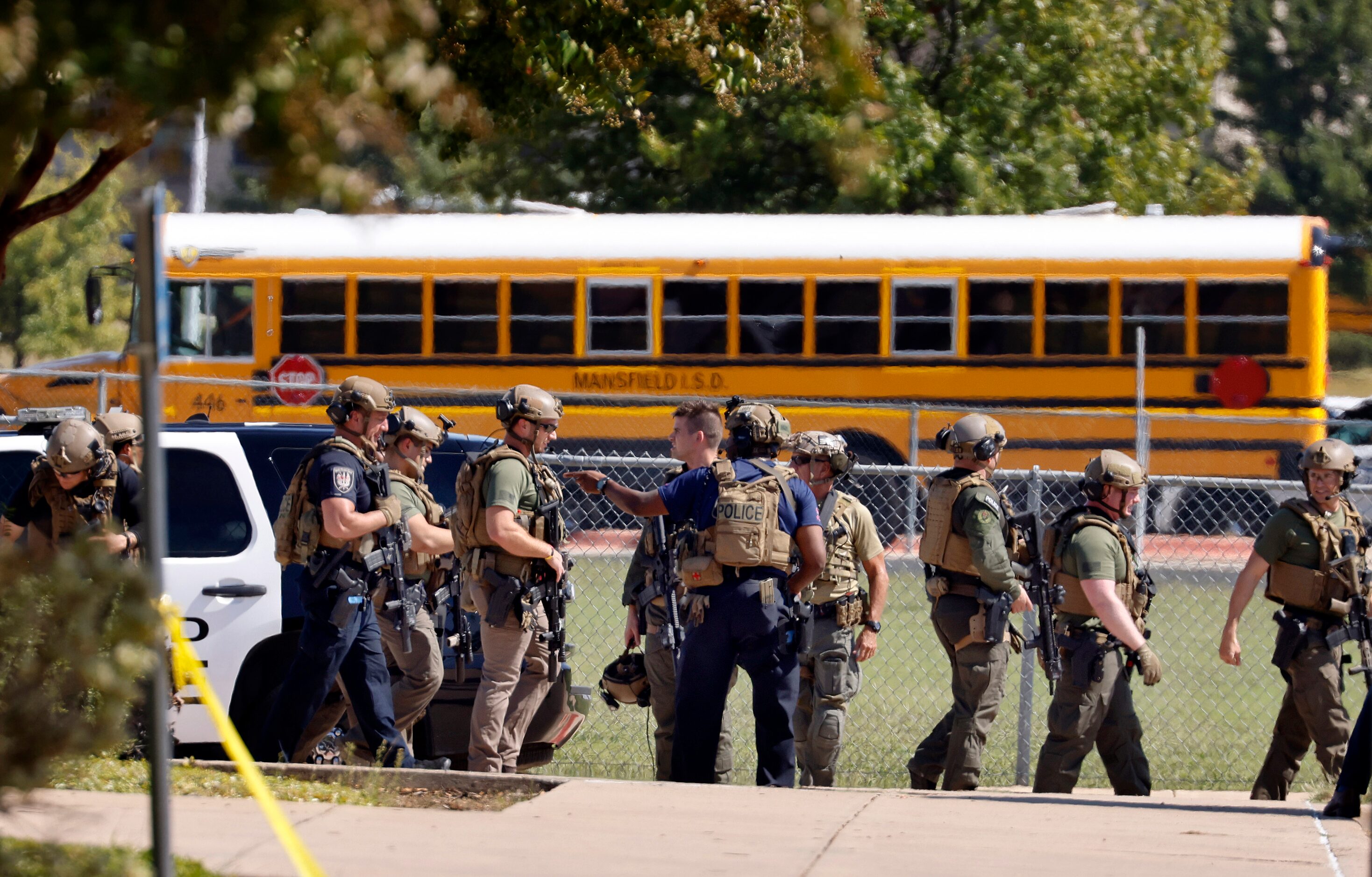 Tactical officers clear the scene following a shooting inside Mansfield Timberview High...