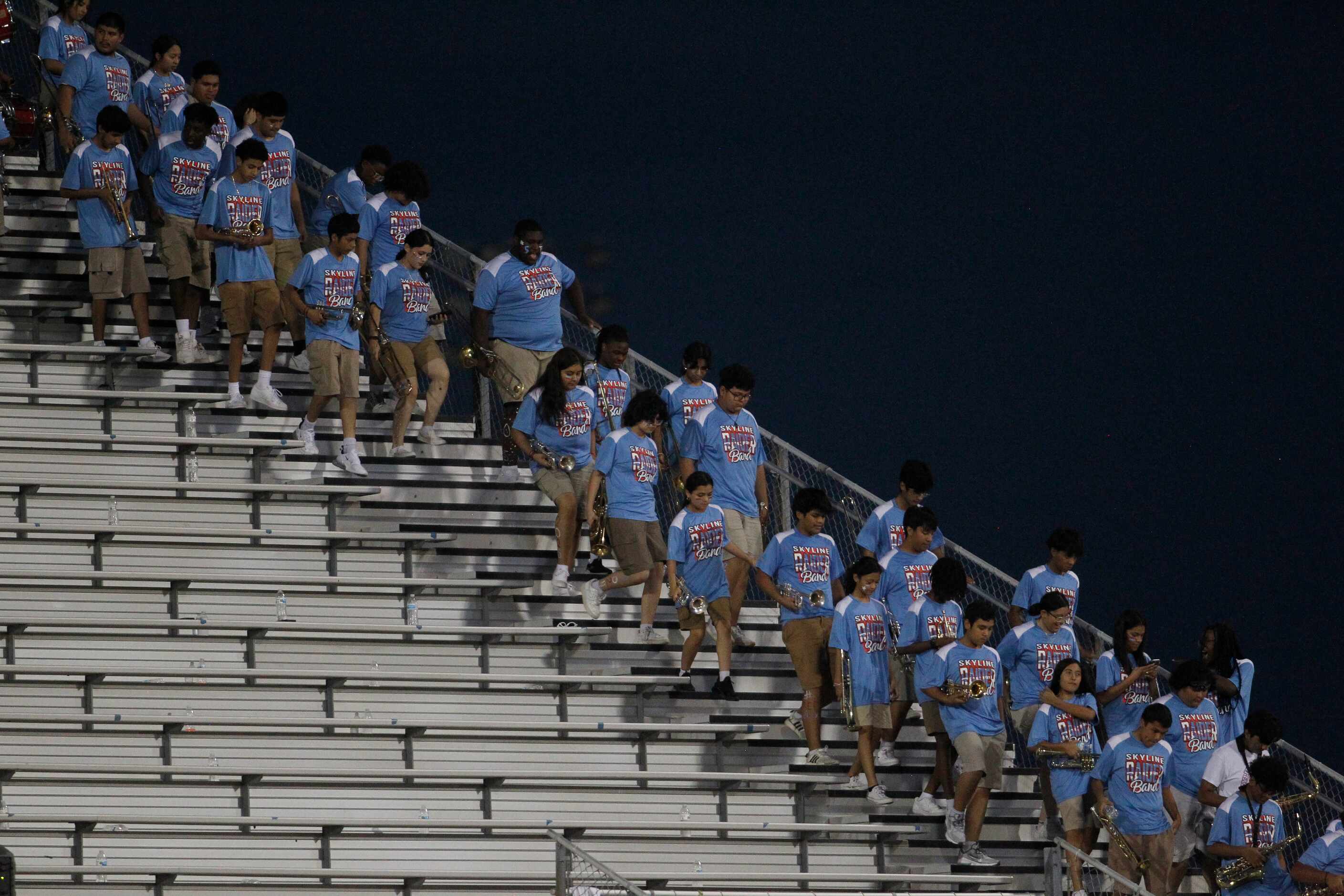 Members of the Dallas Skyline band exit the stands in preparation for their performance on...