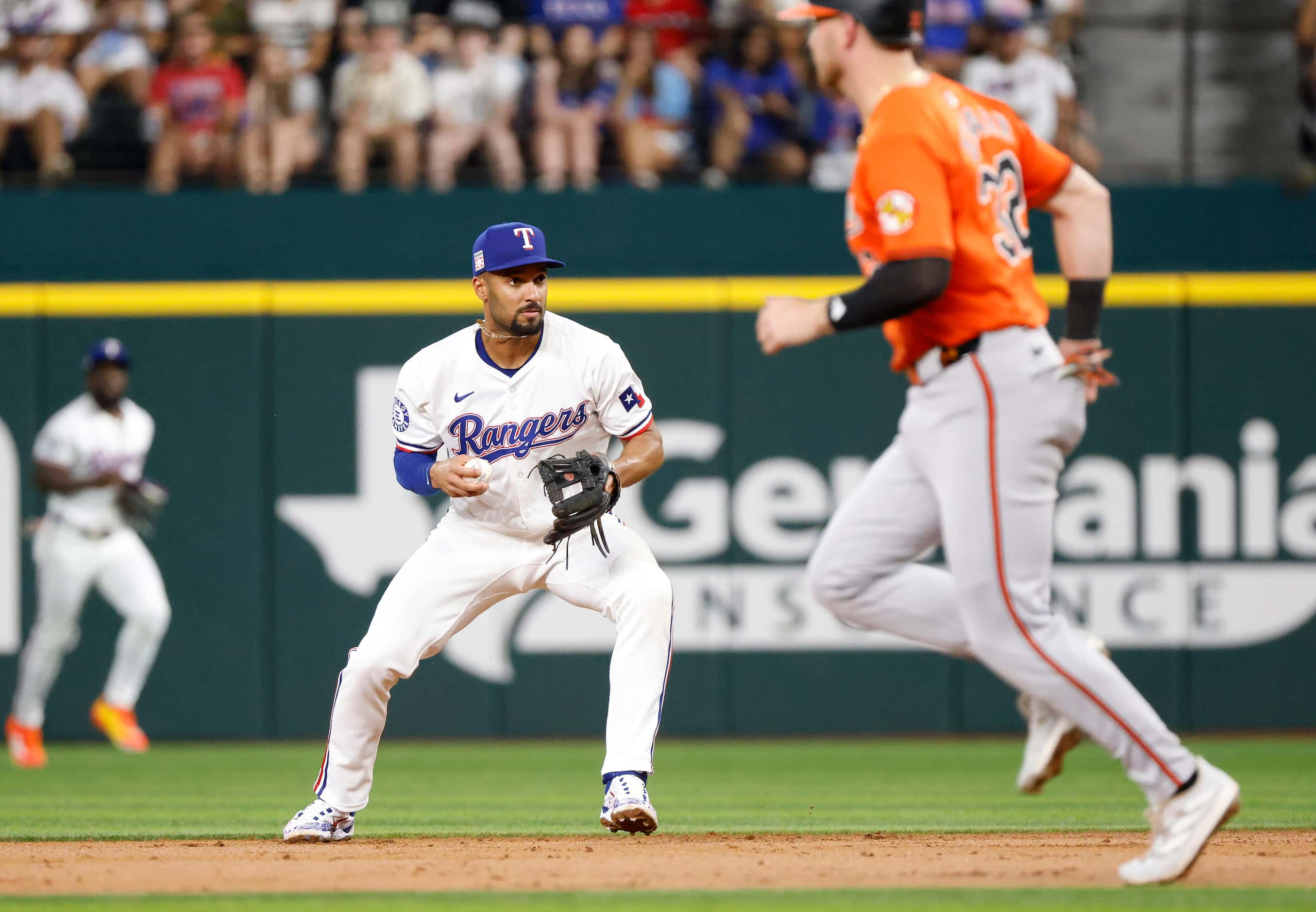 Texas Rangers second base Marcus Semien (2) fields an infield ball before throwing out...