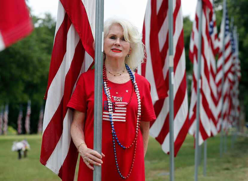 Ruth Ann Cameron of Dallas stands next to the flag that was draped on the casket of her...