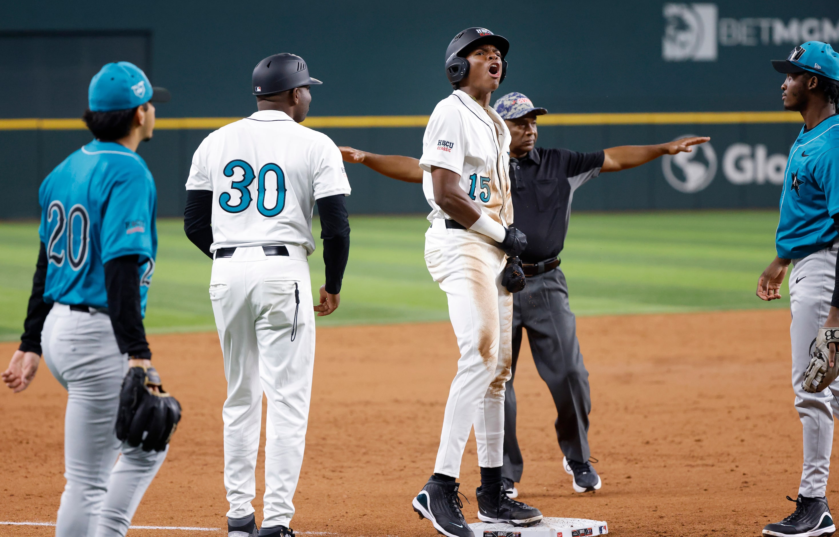 American League batter Robert Tate Jr.(15) reacts after hitting a triple during the third...