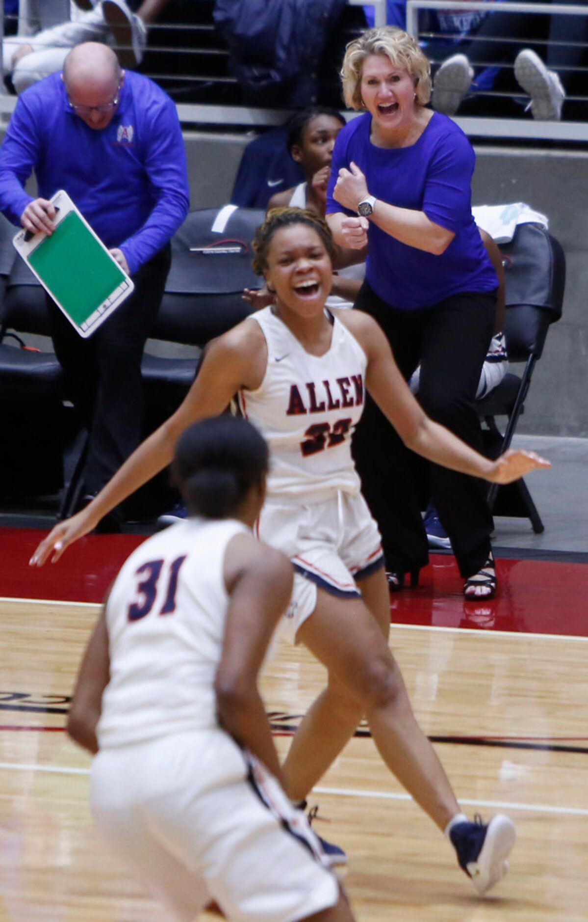 Allen head coach Teresa Durham was all smiles as Allen forward Tyler Jackson (22) and guard...