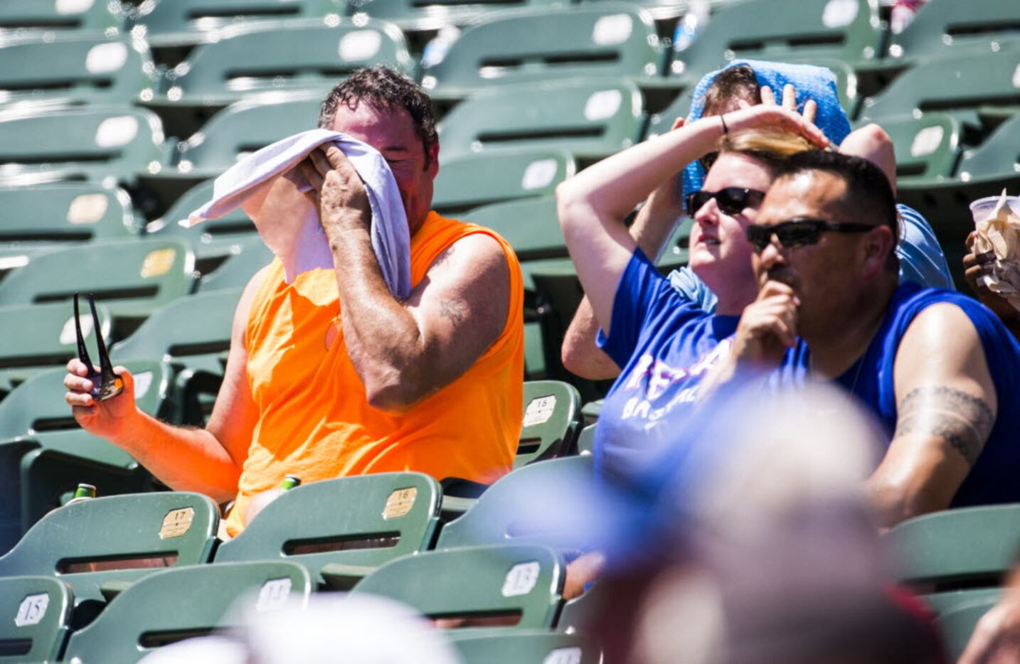 A sweaty Texas Rangers fan toweled off in the sizzling section of Globe Life Park in...