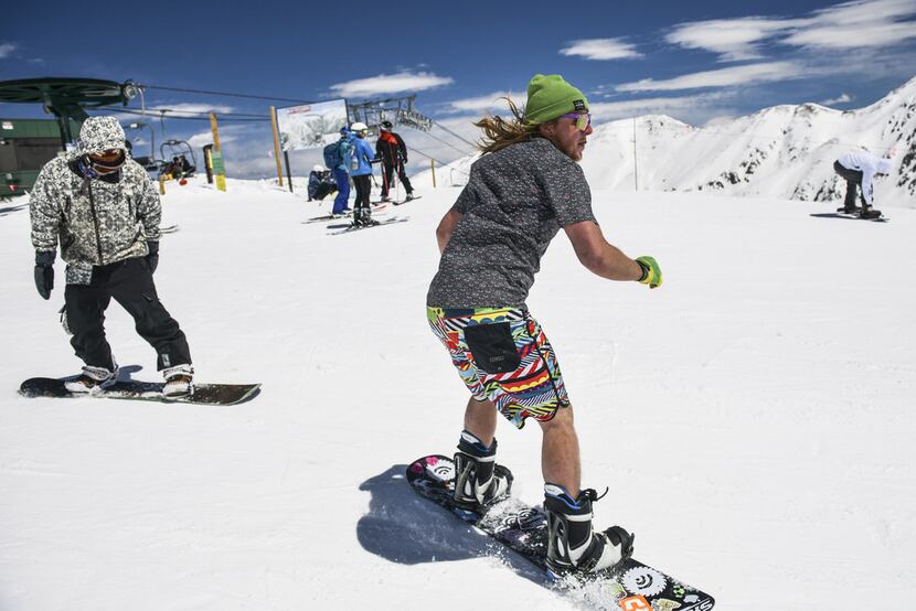 A snowboarder wearing shorts and a T-shirt enjoyed spring conditions at Arapahoe Basin Ski...