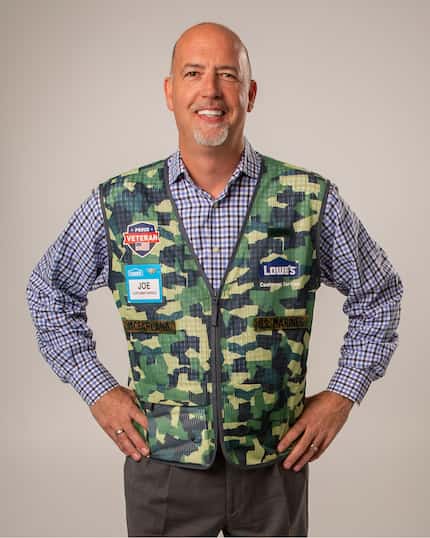 Joe McFarland stands wearing a camouflage vest for Lowe's veteran employees.