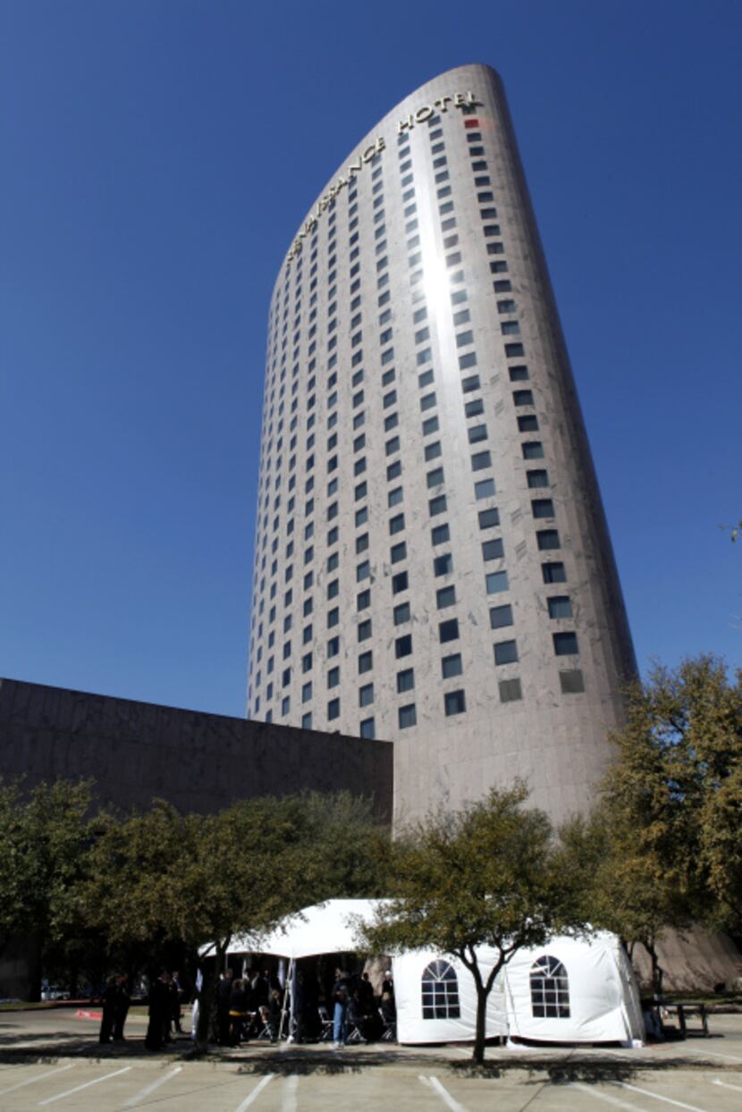 A tent set up for the groundbreaking is dwarfed by Renaissance Dallas, recognizable for its...