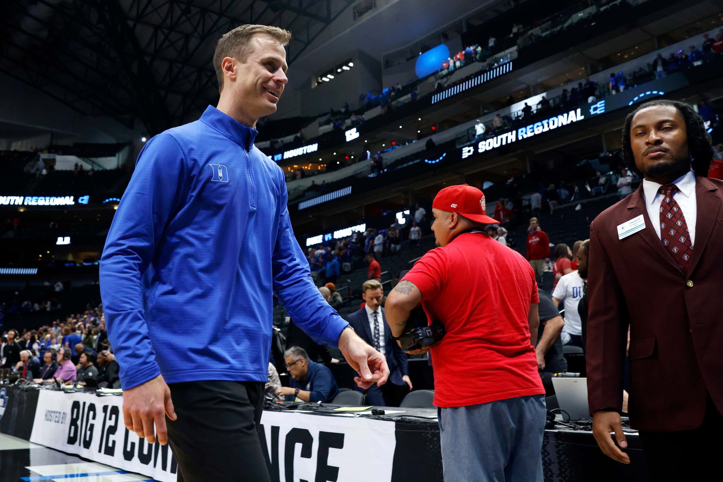Duke head coach Jon Scheyer smiles as he walks off the court after winning an NCAA Men’s...
