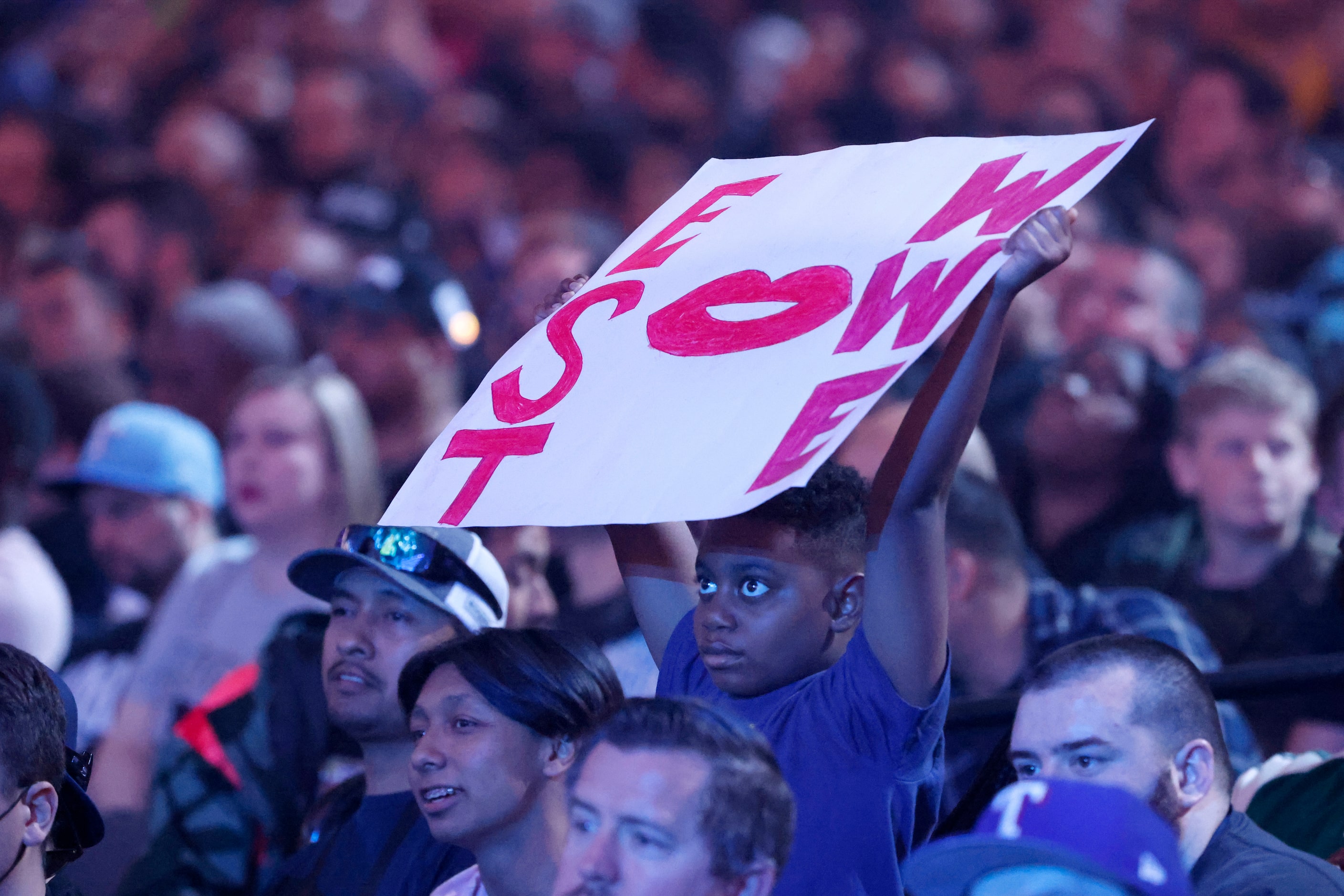 A fan watches  a bout between Becky Lynch an  Bianca Belair during WrestleMania in...