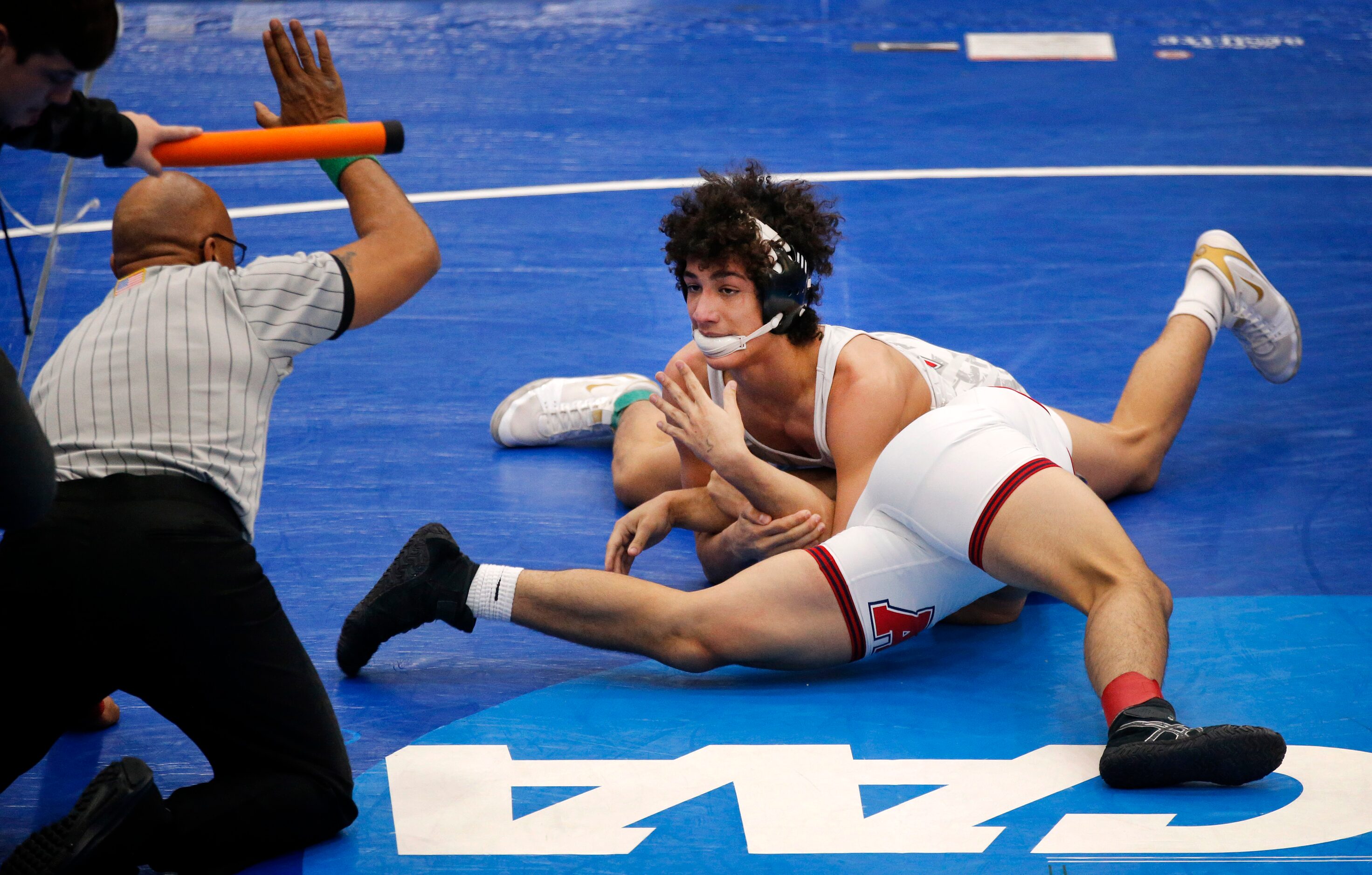 Cedar Park Vista Ridge wrestler Aaron Lofton (facing) trees to pin Allen High Eagles...