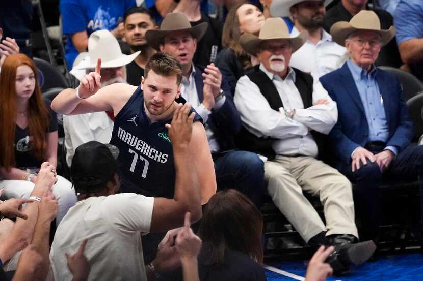 Dallas Mavericks guard Luka Doncic (77) celebrates after scoring during the third quarter in...