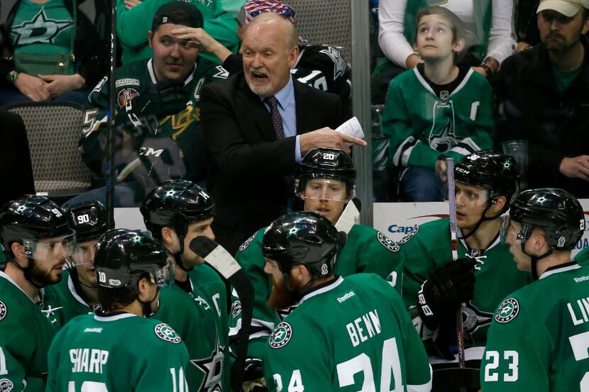 Stars head coach Lindy Ruff talks with his players during a timeout in the third period...